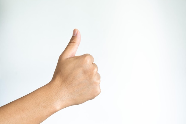 Closeup of asian male right hand showing thumbs up sign against white background