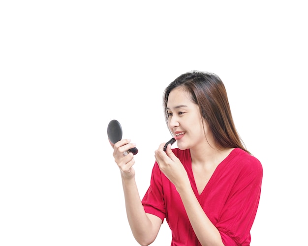 Closeup asian woman are making up by lipstick isolated on white background