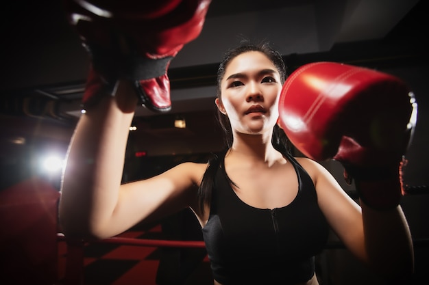 Closeup asian woman doing boxing exercise at the gym