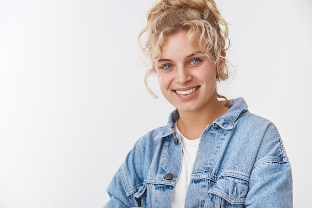Closeup attractive friendly sociable blonde scandinavian girlfriend curly combed hairstyle smiling broadly white teeth standing satisfied white background grinning happily pleased receive service