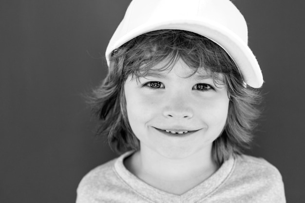 Closeup attractive laughing boy Child emotions concept Portrait of young smiling kid outdoor Blur background Funny kids face