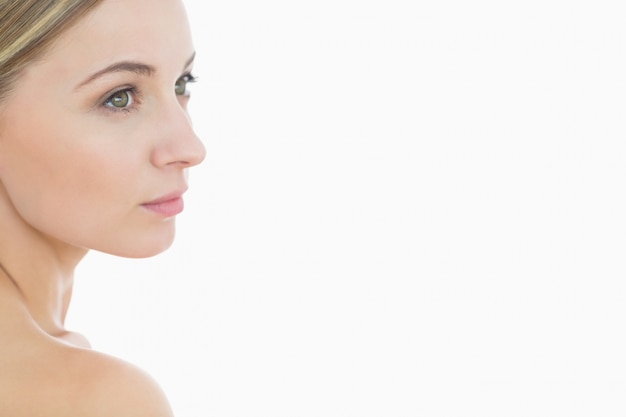 Closeup of attractive young woman looking away