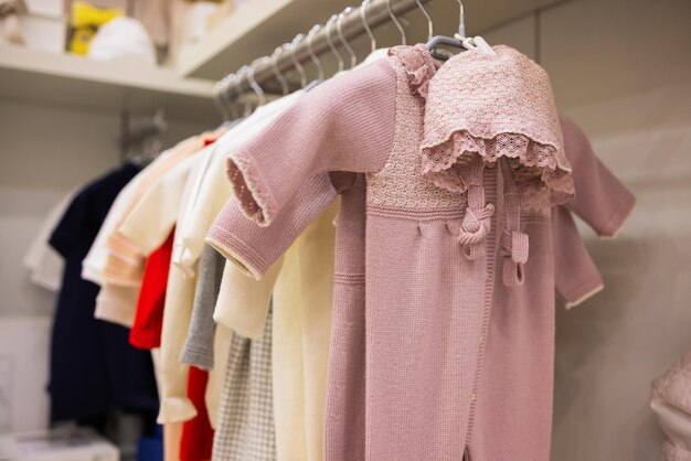 Closeup of baby clothes on rack in a flea market.