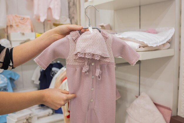 Closeup of baby clothes on rack in a flea market.