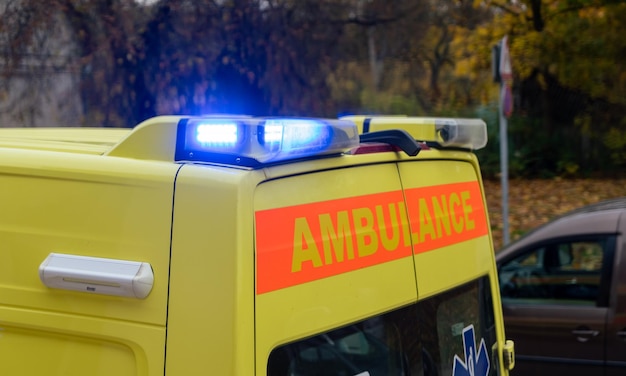 Closeup of back of ambulance switched lights on the street