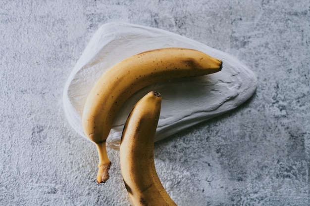 Closeup of bananas on gray textured background