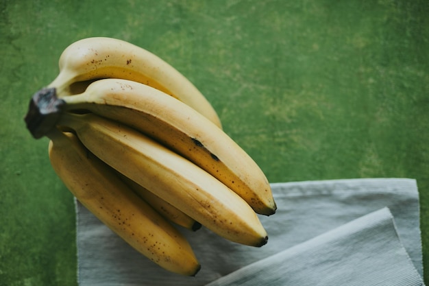 Closeup of bananas on green background