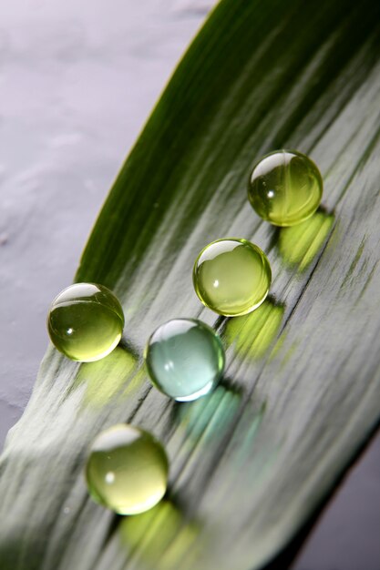 Closeup of bath pearls on green leaf