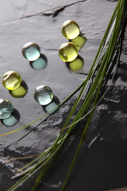 Closeup of bath pearls on wet slate