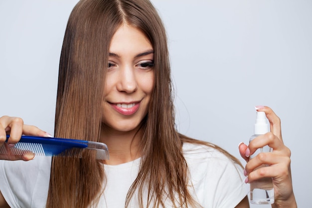 Closeup Of Beautiful Woman Hairbrushing Hair With Brush