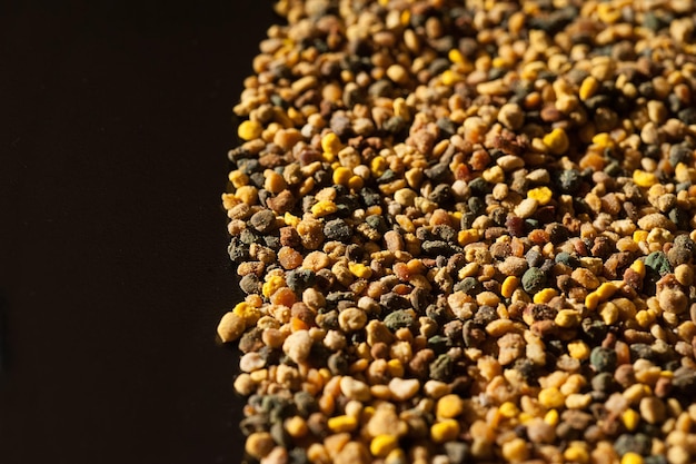 Closeup of bee pollen on black organic medicinal food top view