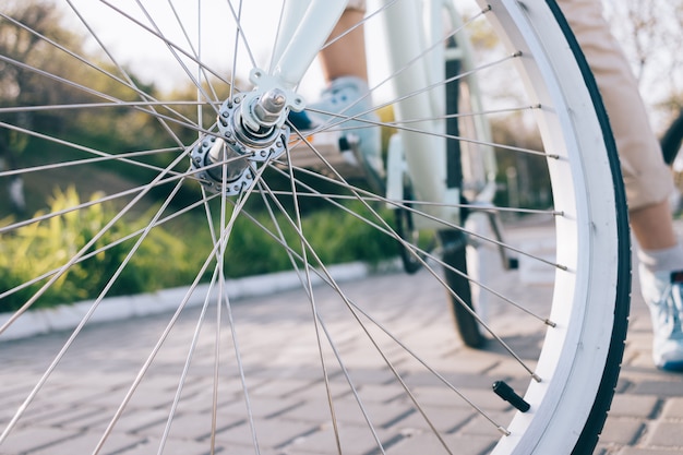 Closeup of bike wheel with chrome spokes