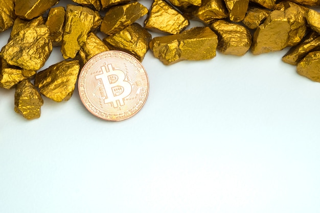 Closeup of bitcoin digital currency and gold nugget