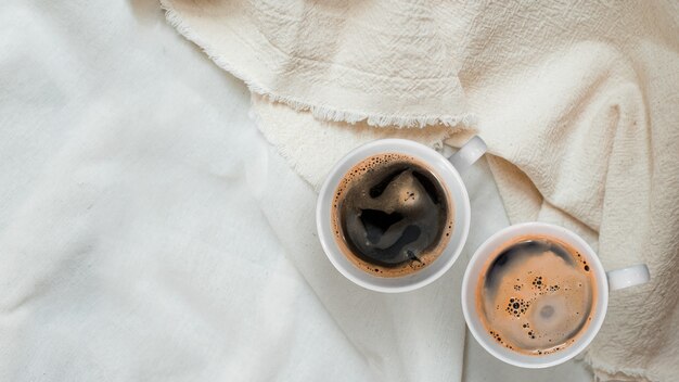 Closeup black coffee cup put on linen fabric top view