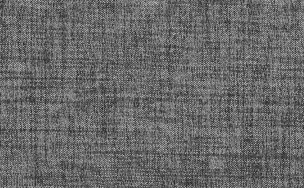 Closeup black dark grey color fabric sample texture backdrop.