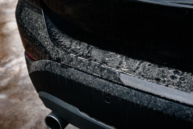 Closeup of black dirty car.