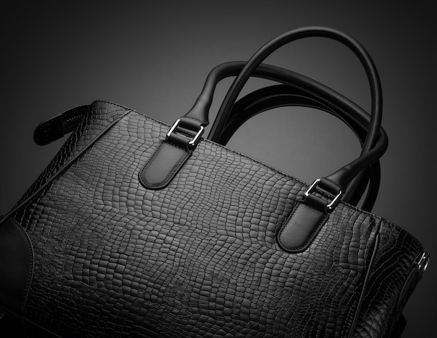 Closeup of a black fashionable women's bag on a dark background