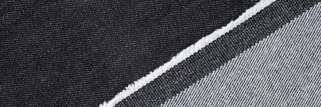 Closeup of black and grey denim fabric texture background abstract material for clothing