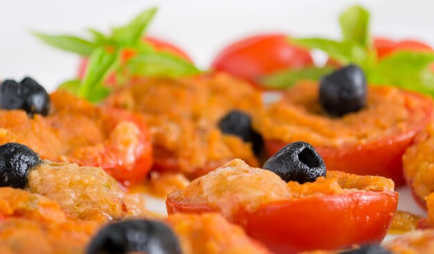 Closeup of a black olives on a stuffed tomato