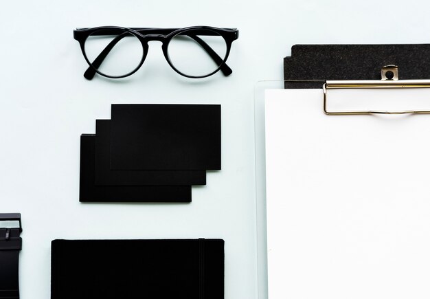 Closeup of black paper cards with eyeglasses on table