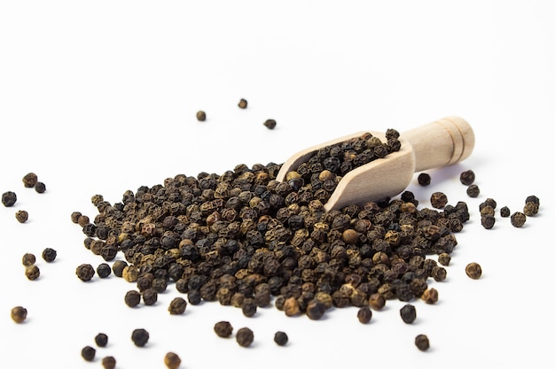 closeup of black peppercorns with wooden spatula macro photography Spices for cooking food