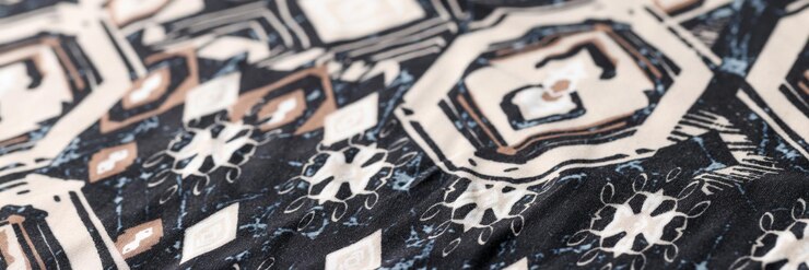 Photo closeup of black and white cotton fabric with geometric shapes and figures texture background
