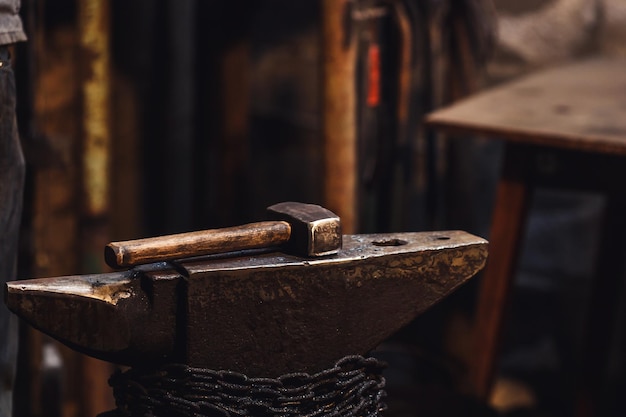 Photo closeup of a blacksmith's hammer on the anvil.