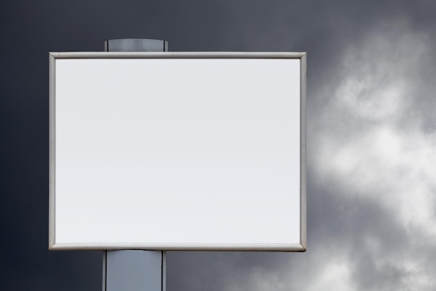 Closeup on a blank billboard against a threatening sky