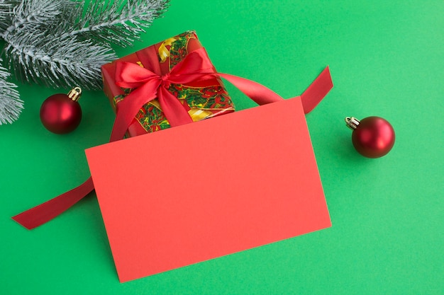 Closeup on blank red paper for Christmas greetings and gift  on the green background