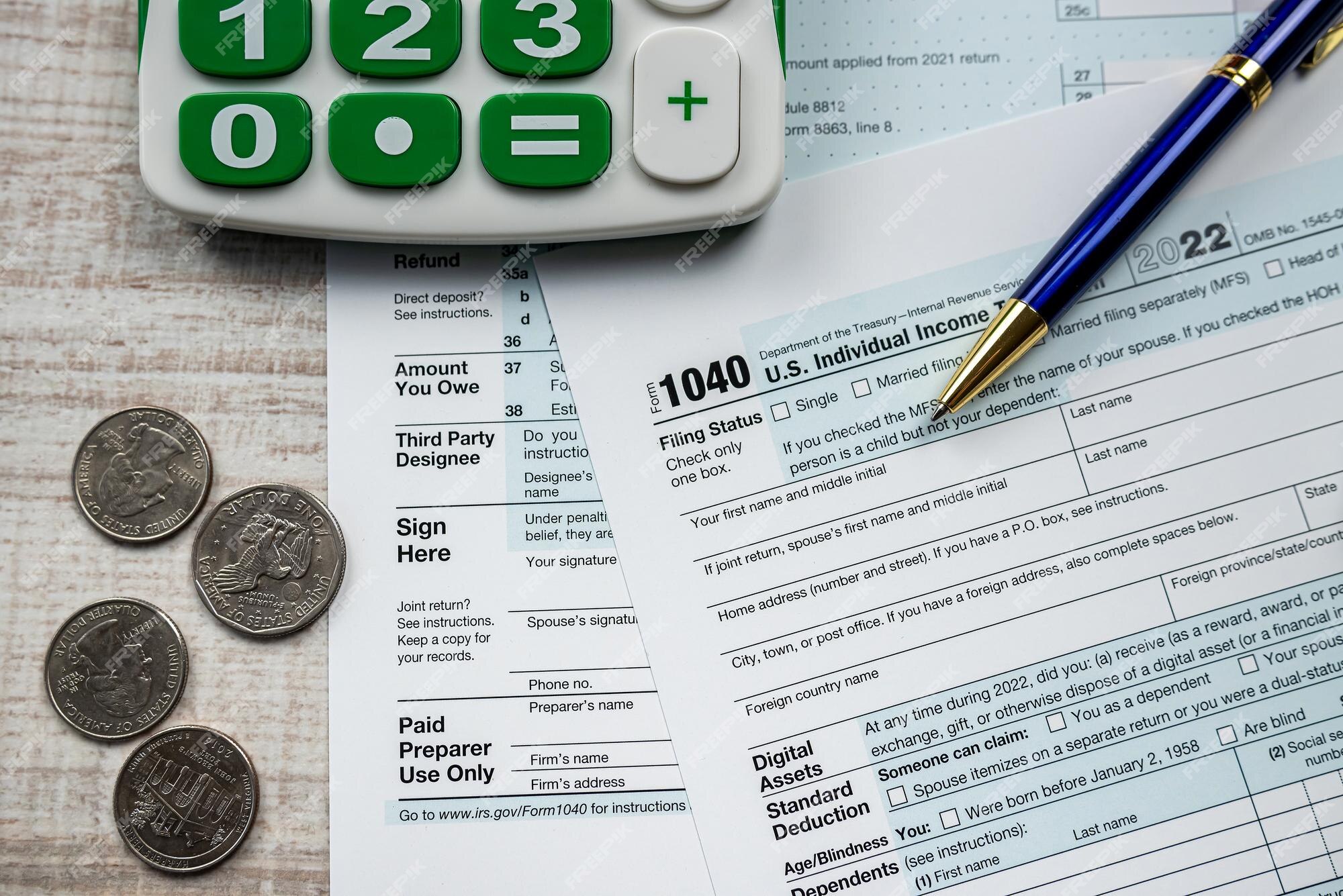 Premium Photo  Pen and coins on the tax form