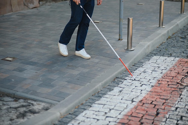 Closeup Of A Blind Man Standing With White Stick On Street
