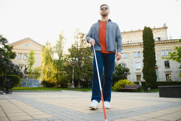 Closeup Of A Blind Man Standing With White Stick On Street