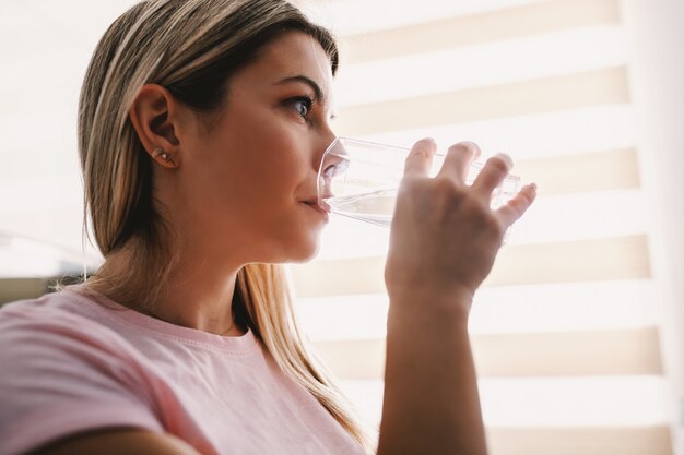 Closeup of blonde drinking water.