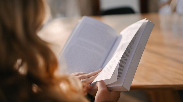 Closeup of a blonde woman reading a book