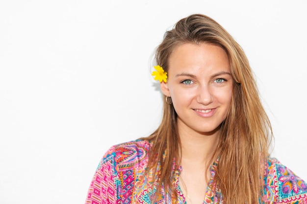 Closeup of blonde woman with daisy in her hair