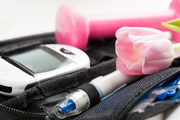 Photo closeup of blood glucose meter and needle