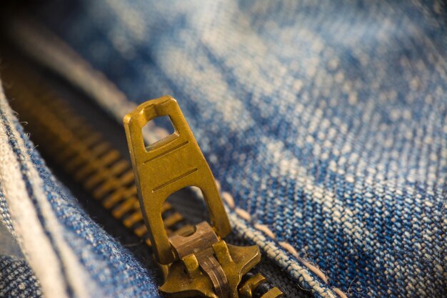 Closeup on blue jeans zipper and button