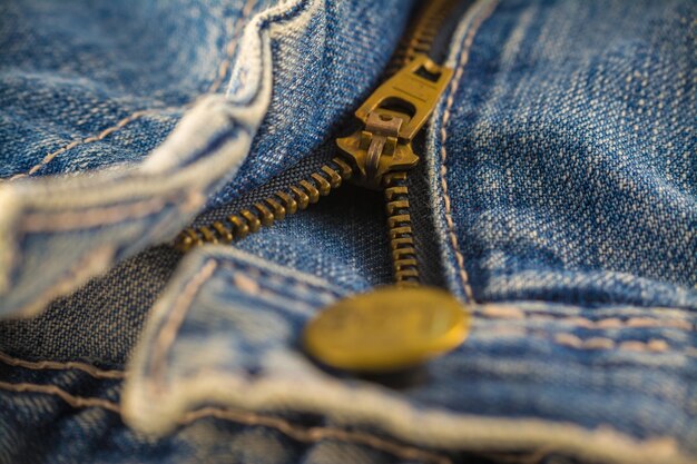 Closeup on blue jeans zipper and button