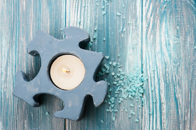 Closeup of blue lit candle and bath salt 