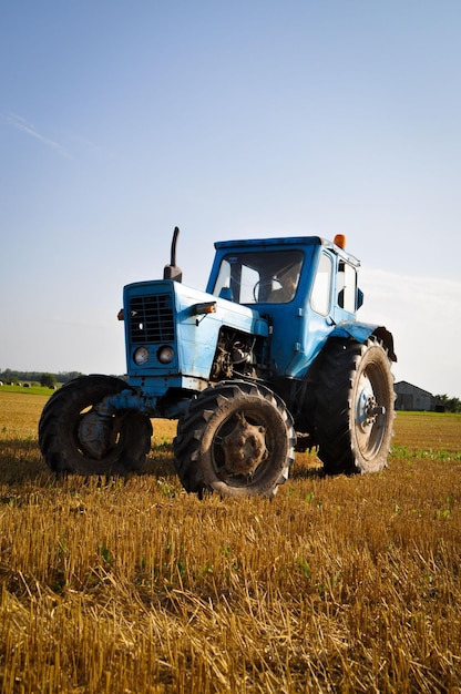 Closeup of a blue tractor parked in an open field