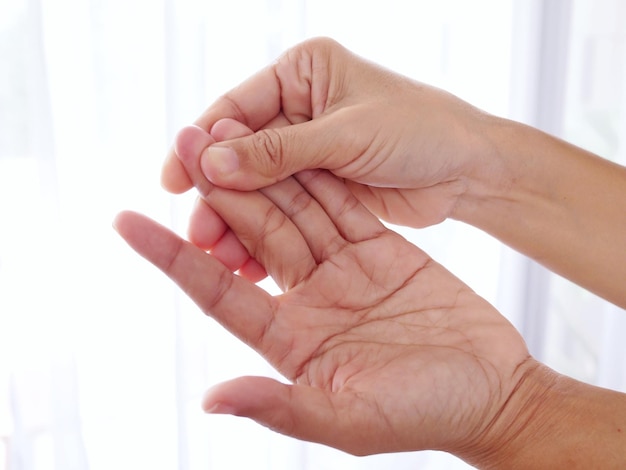 Closeup of body people with hand pain sore finger and numbness in fingertips Rheumatoid arthritis