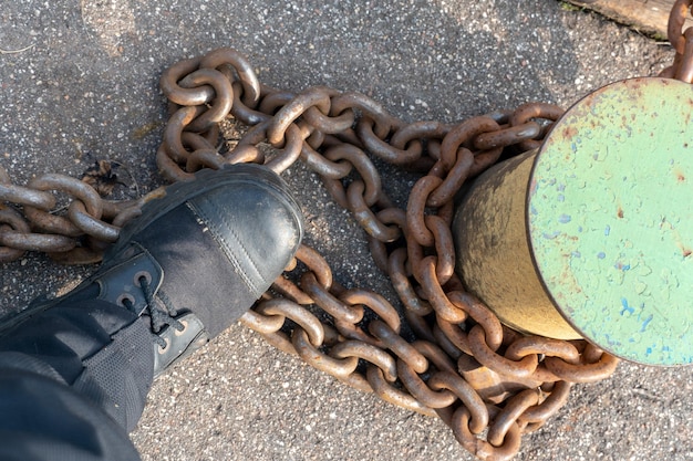 Closeup of bollards and iron chains on an old River barge Securing the ship with a large chain Old rusty vintage mooring bollard for boats ships and yachts Control system for the ferry