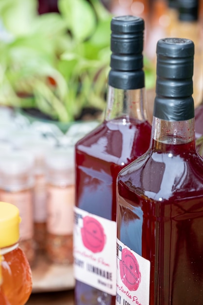 Closeup of bottles of homemade goods at a market stall