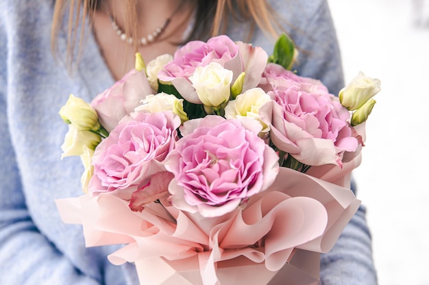 Closeup of a bouquet of roses in female hands