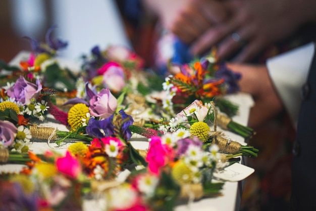 Photo closeup of boutonnieres on a white table