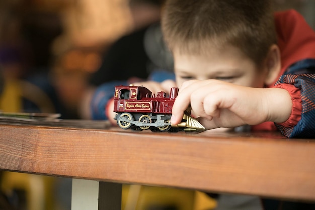 Closeup of a boy playing with a train