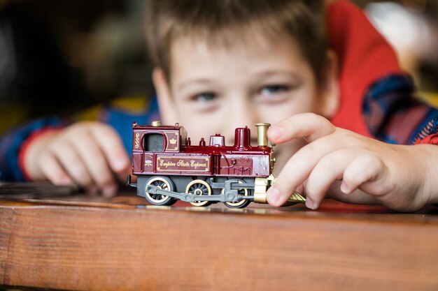 Closeup of a boy playing with a train