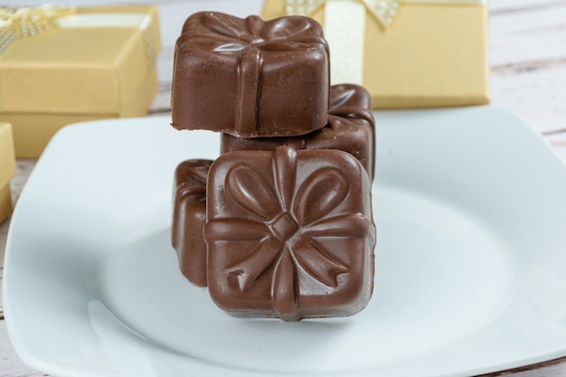 Closeup of brazilian honey cakes stacked. Surrounded by golden gift boxes.