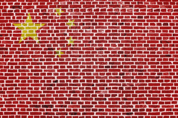 Closeup on a brick wall with the flag of China painted on it