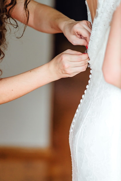 Closeup bride is getting ready in the morning with bridesmaids